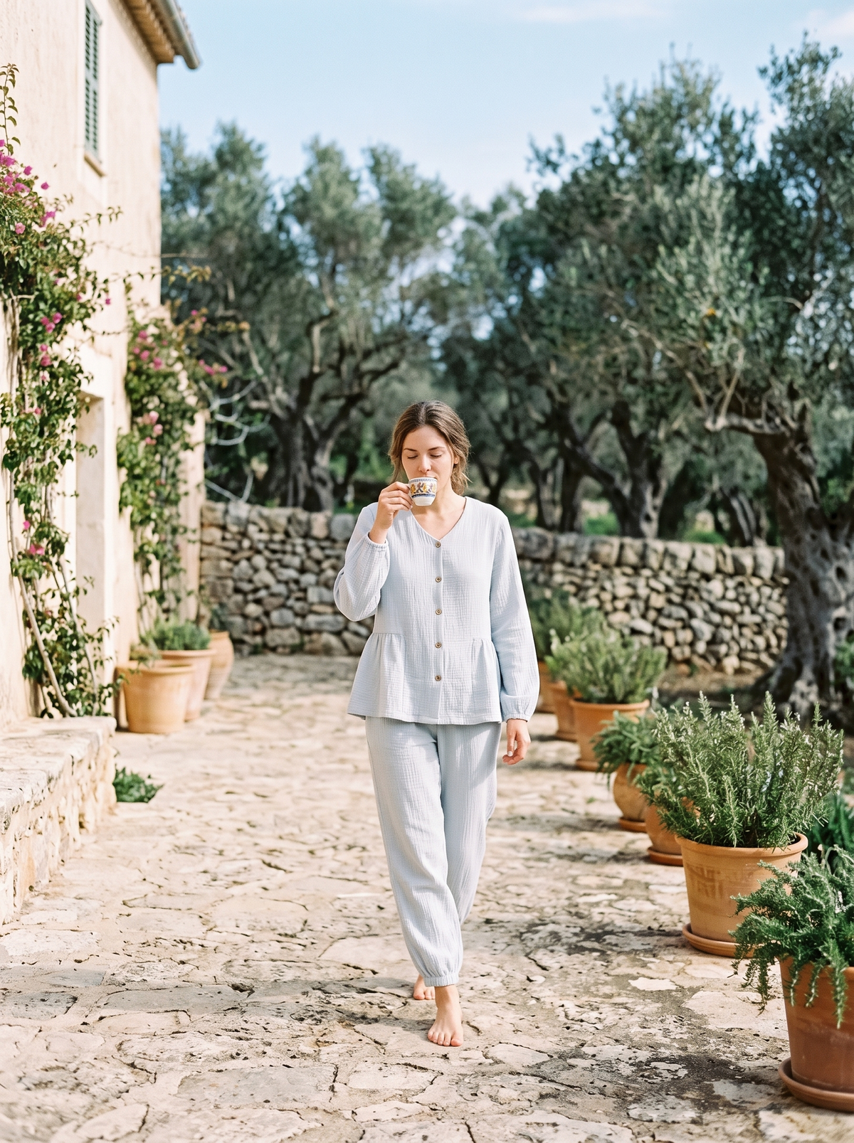The Finca Set in Powder Blue on a stone terrace among olive trees